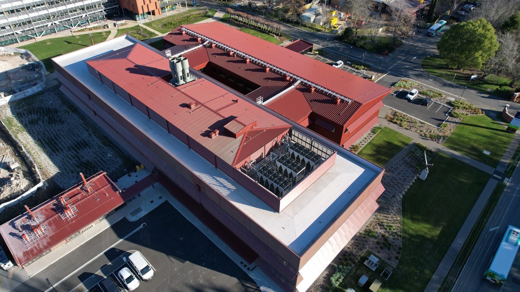 Aerial view of the AgResearch building with a dark red long-run metal roof