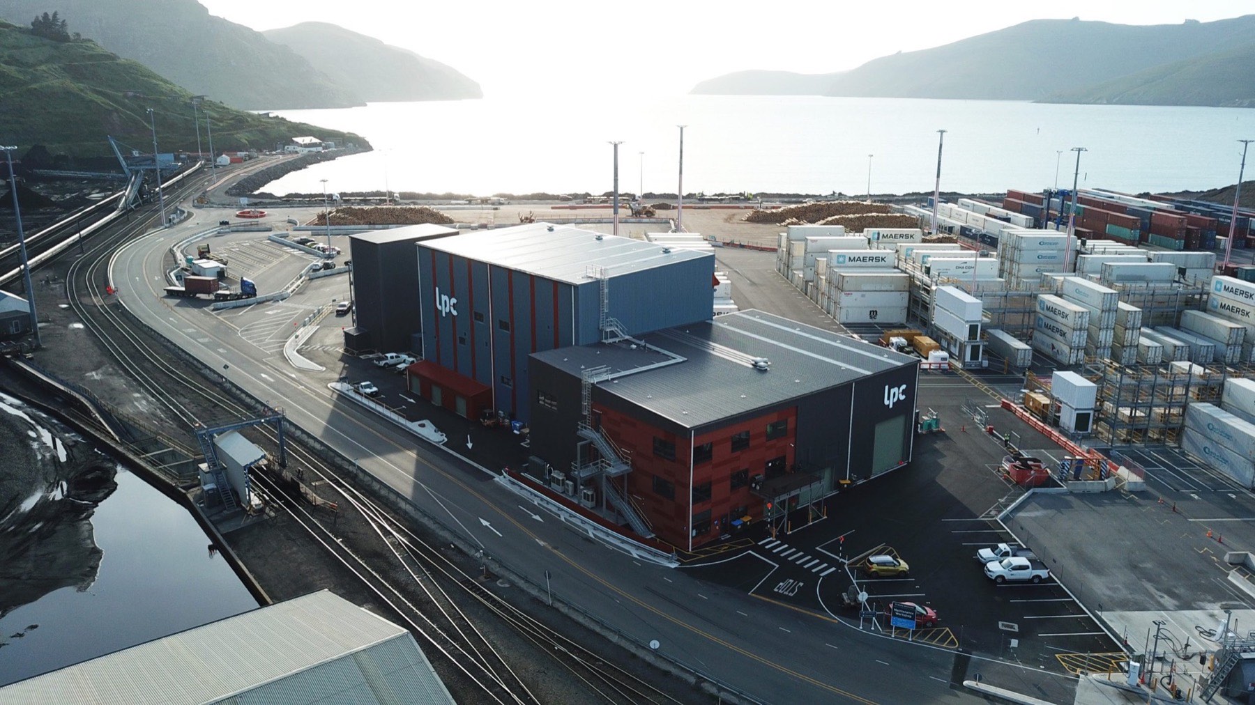 Aerial view of Lyttelton Port Company workshop with dark metal roof and shipping containers